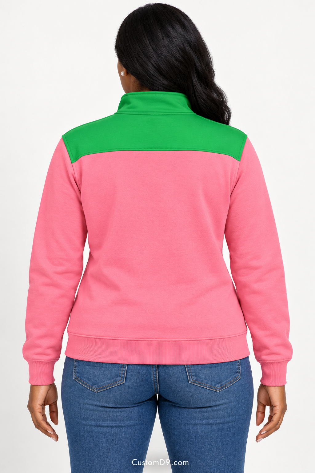 Black female model showing back of Alpha Kappa Alpha salmon pink quarter-zip with apple green shoulder panel