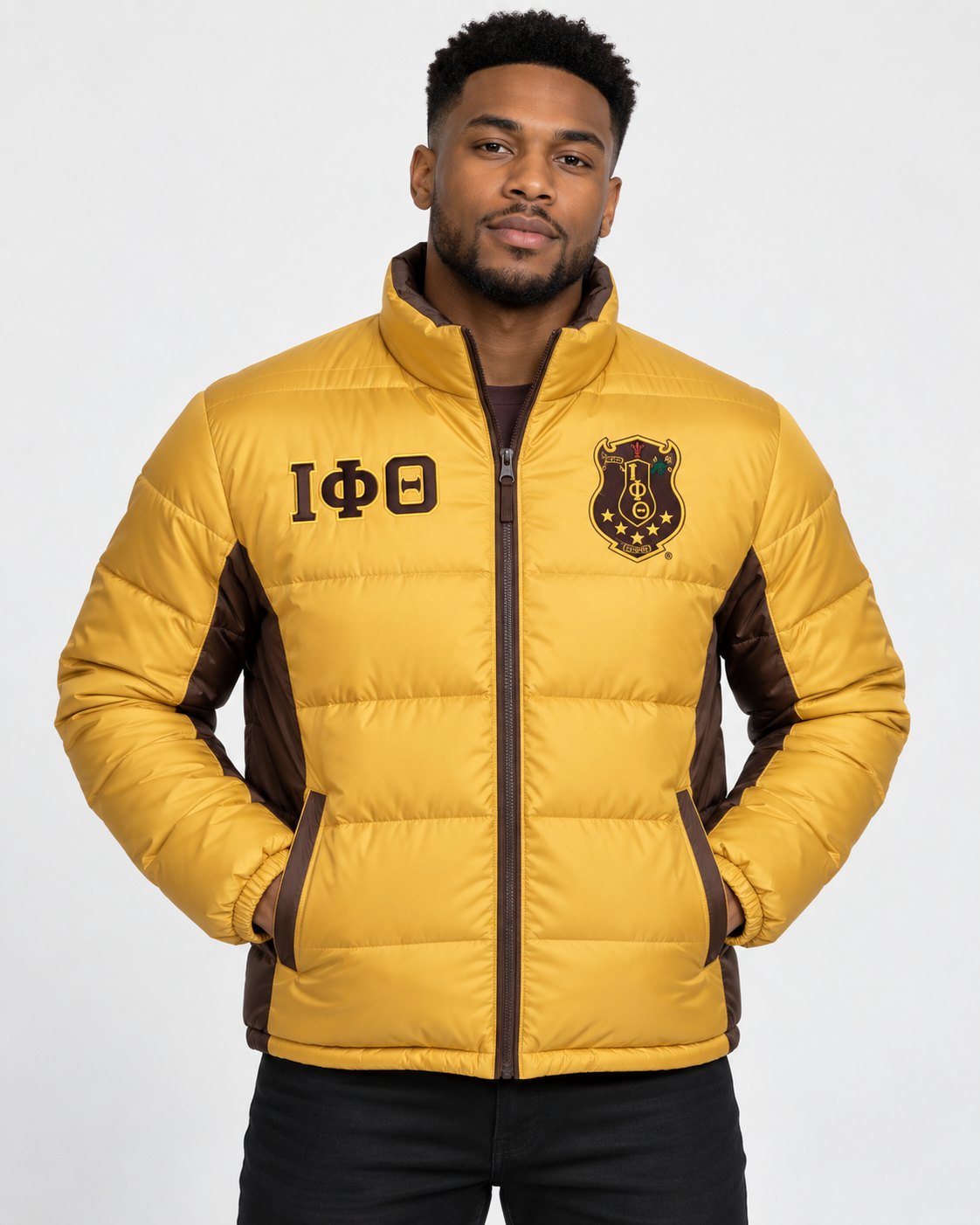 Iota Phi Theta gold puffer jacket with brown contrast and embroidery on male model