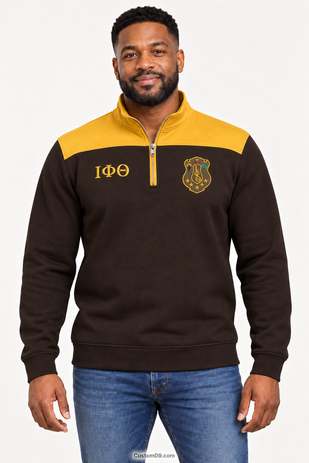 Black male model showing front of Iota Phi Theta charcoal brown quarter-zip with gilded gold shoulder panel