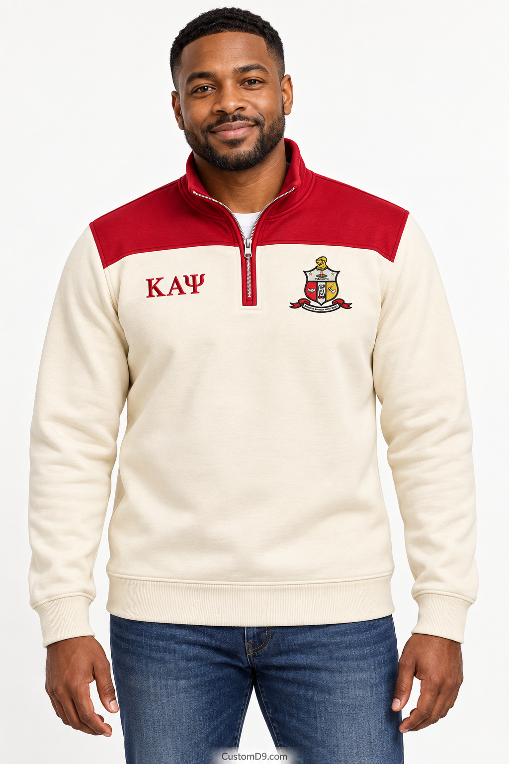 Black male model showing front of Kappa Alpha Psi cream quarter-zip with crimson shoulder panel