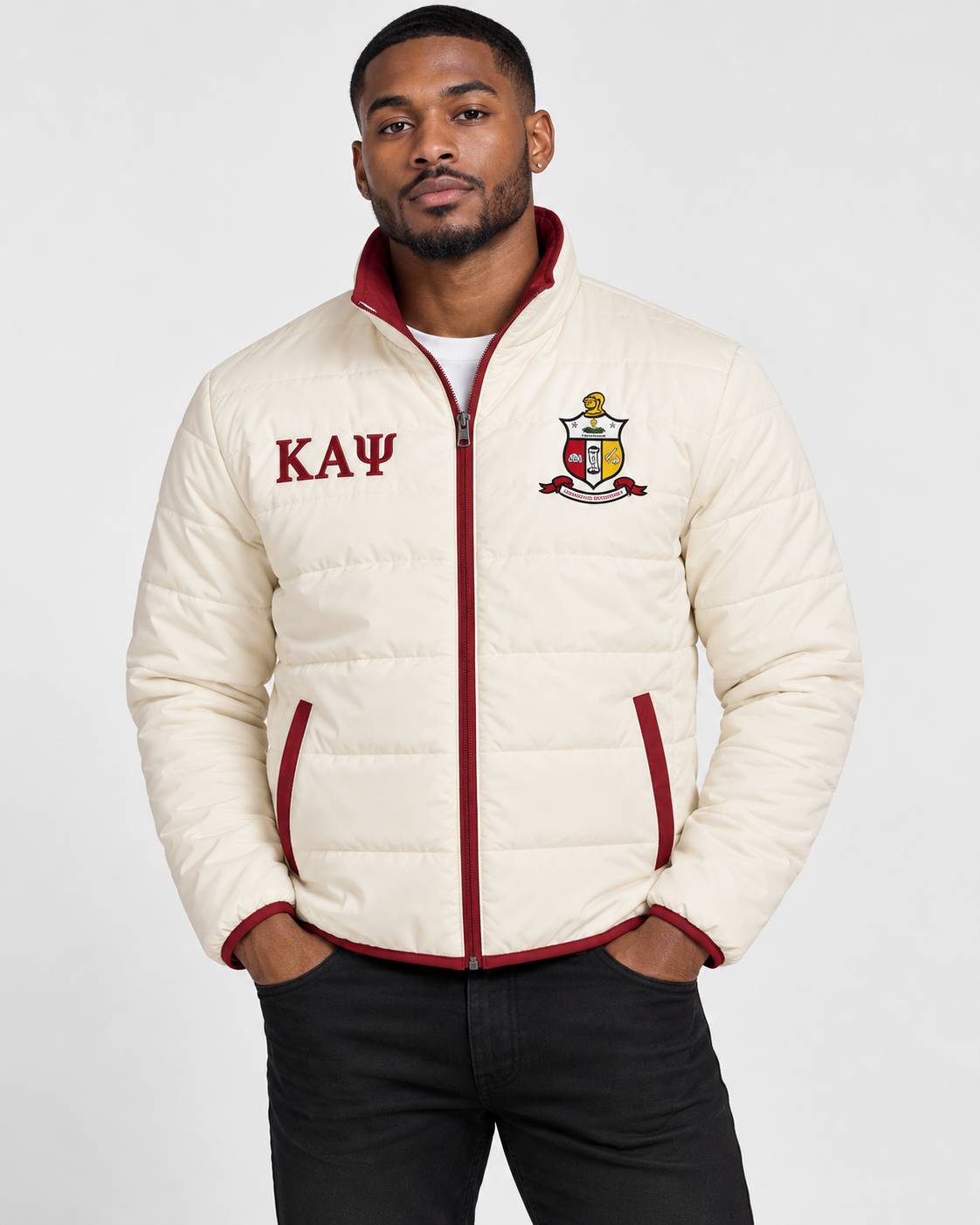 Kappa Alpha Psi cream puffer jacket with crimson contrast and embroidery on male model