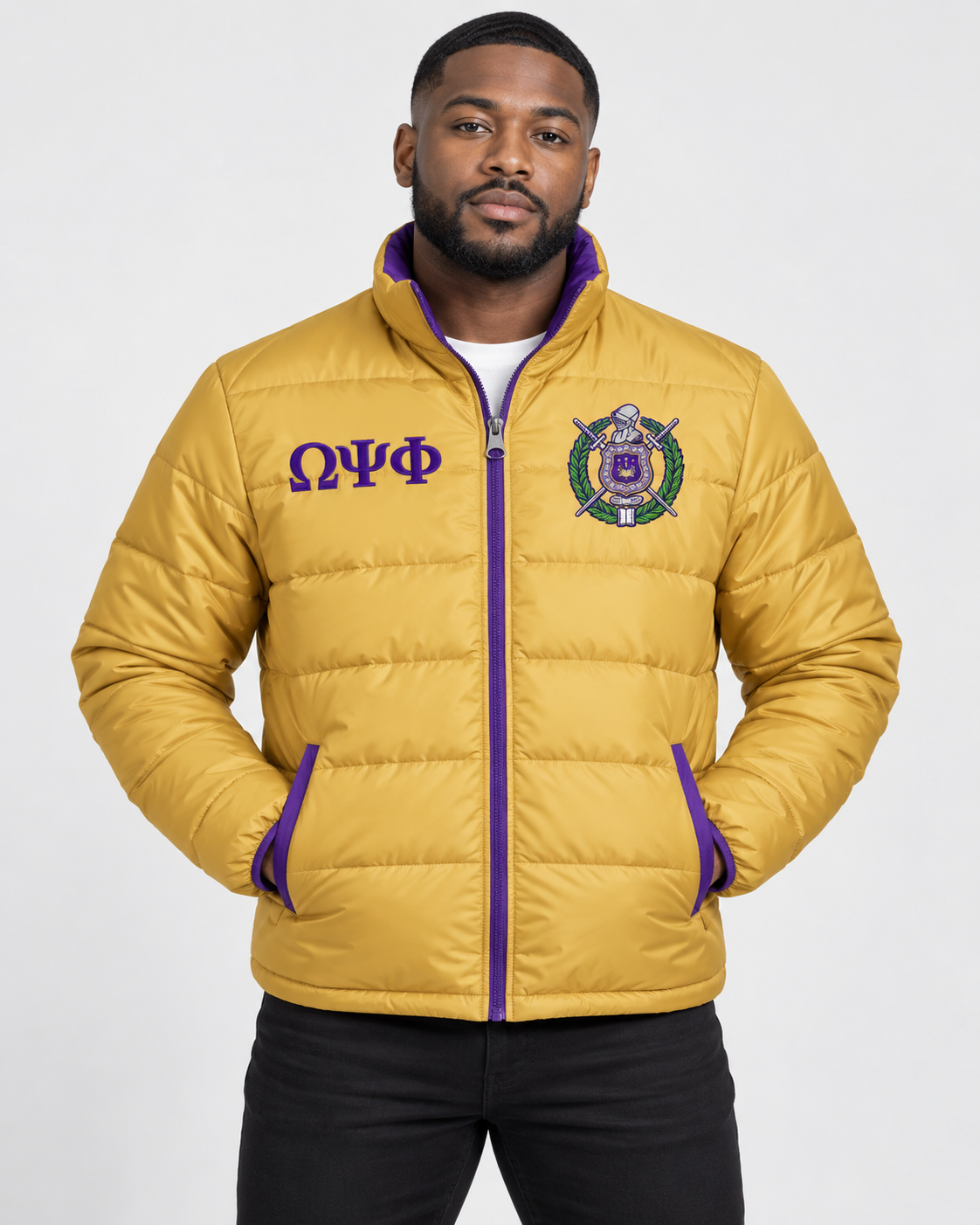 Omega Psi Phi old gold puffer jacket with purple contrast and embroidery on male model