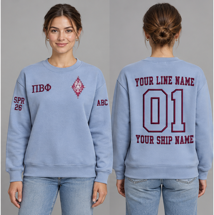 Pi Beta Phi Silvery Blue crewneck sweatshirt on an adult model, Wine Greek letters ΠΒΦ, original supplied crest, sample line name, line number 01 and ship name, right sleeve SPR 26 and left sleeve ABC.