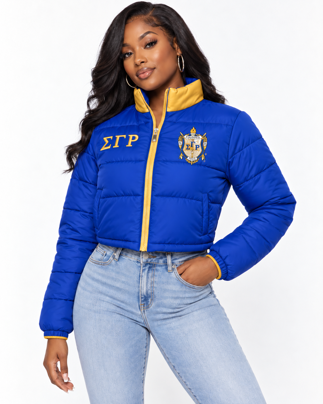 Sigma Gamma Rho royal blue cropped puffer jacket with gold contrast and embroidery on female model
