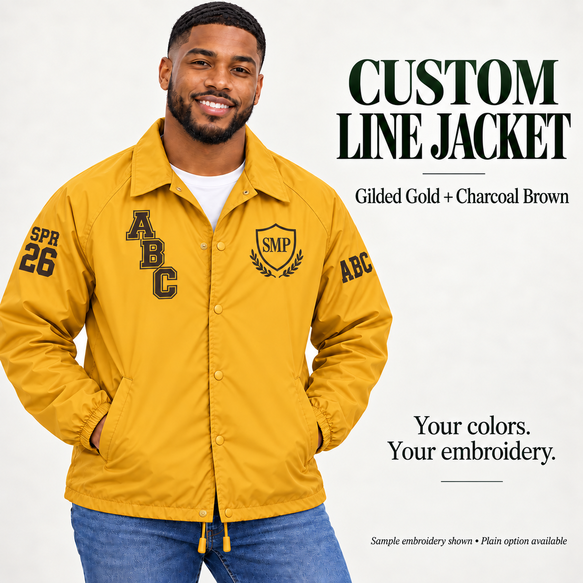 Gilded Gold nylon snap-front line jacket with charcoal brown sample embroidery on a male model