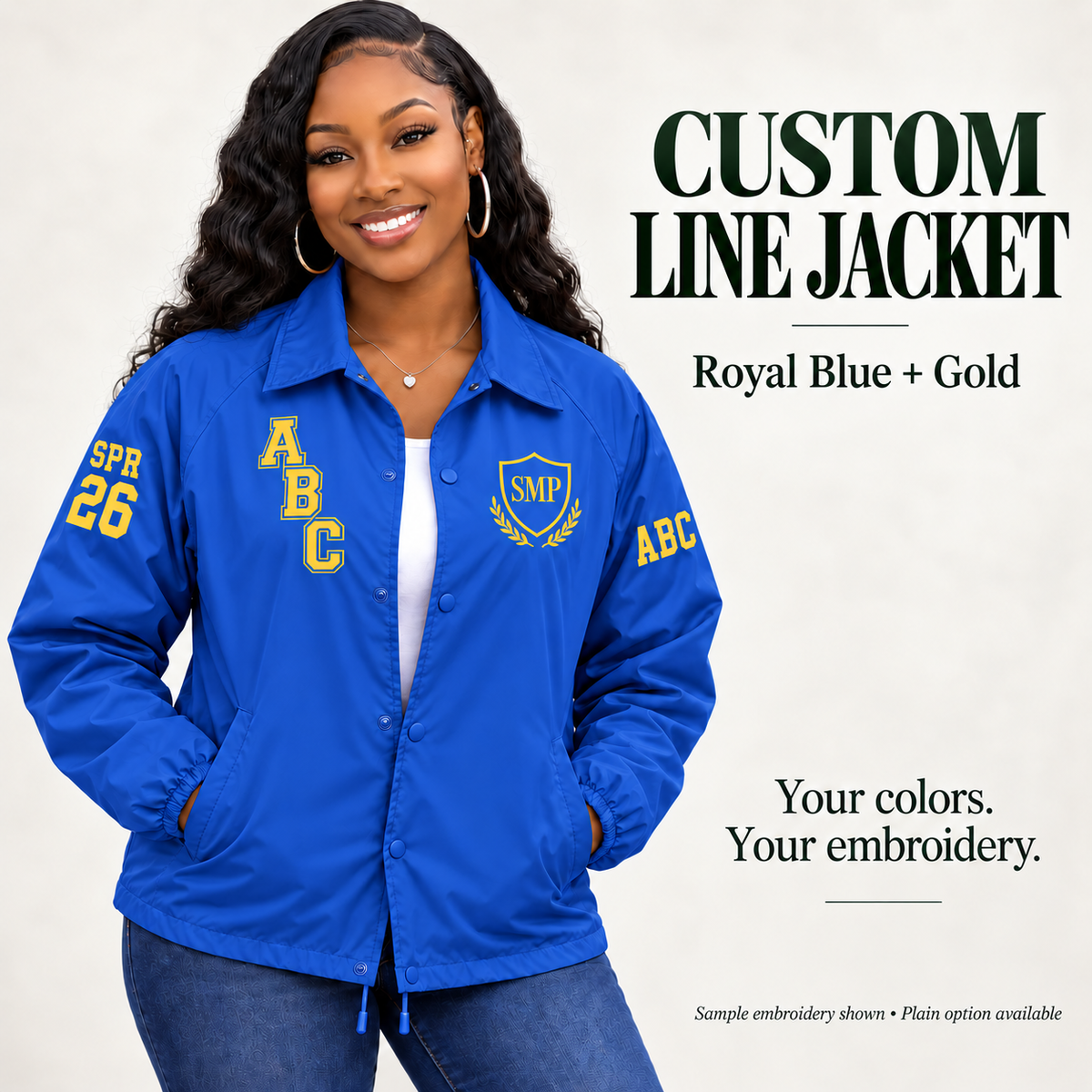 Royal Blue nylon snap-front line jacket with gold sample embroidery on a female model