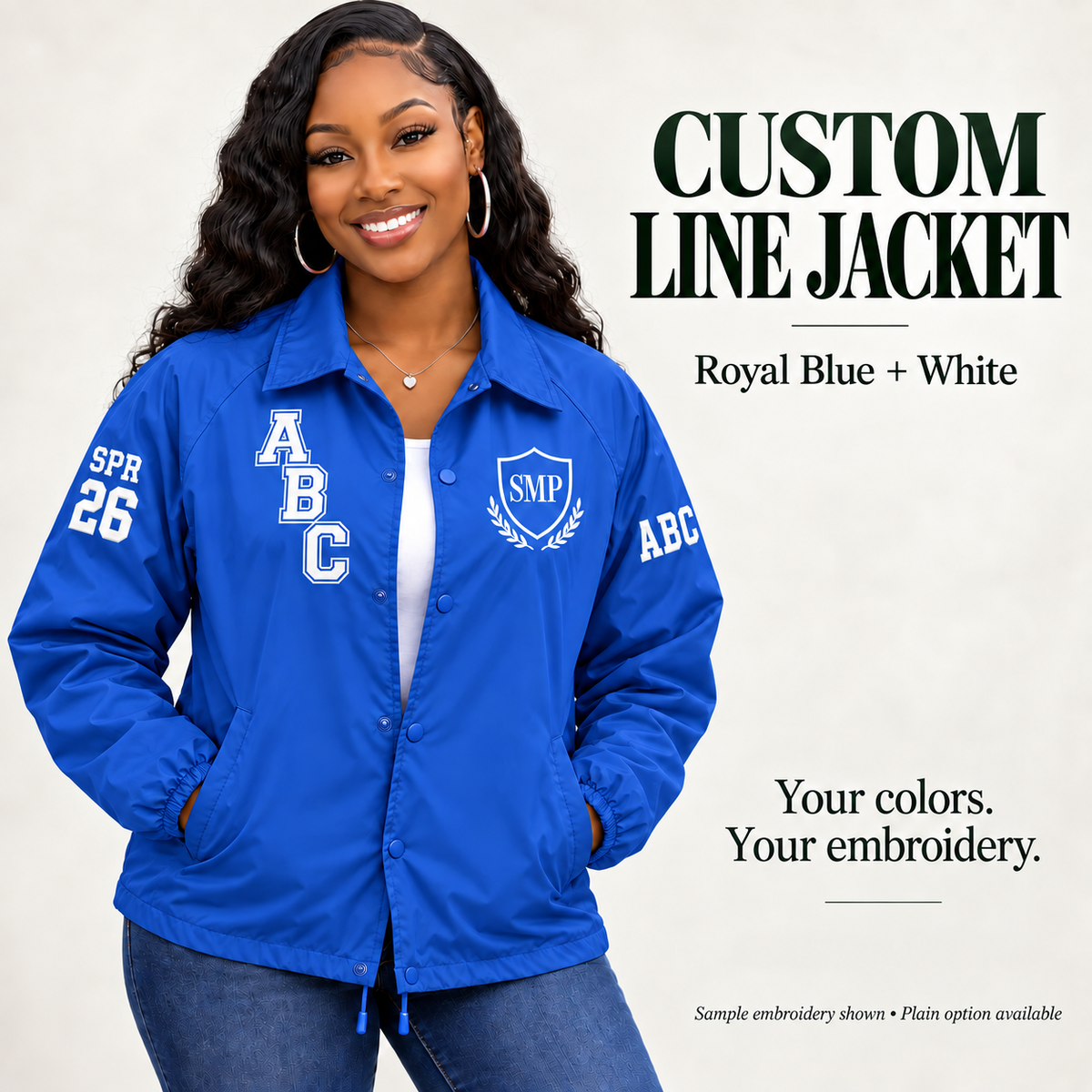 Royal Blue nylon snap-front line jacket with white sample embroidery on a female model