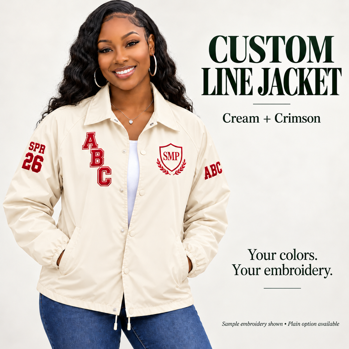Cream nylon snap-front line jacket with crimson sample embroidery on a female model