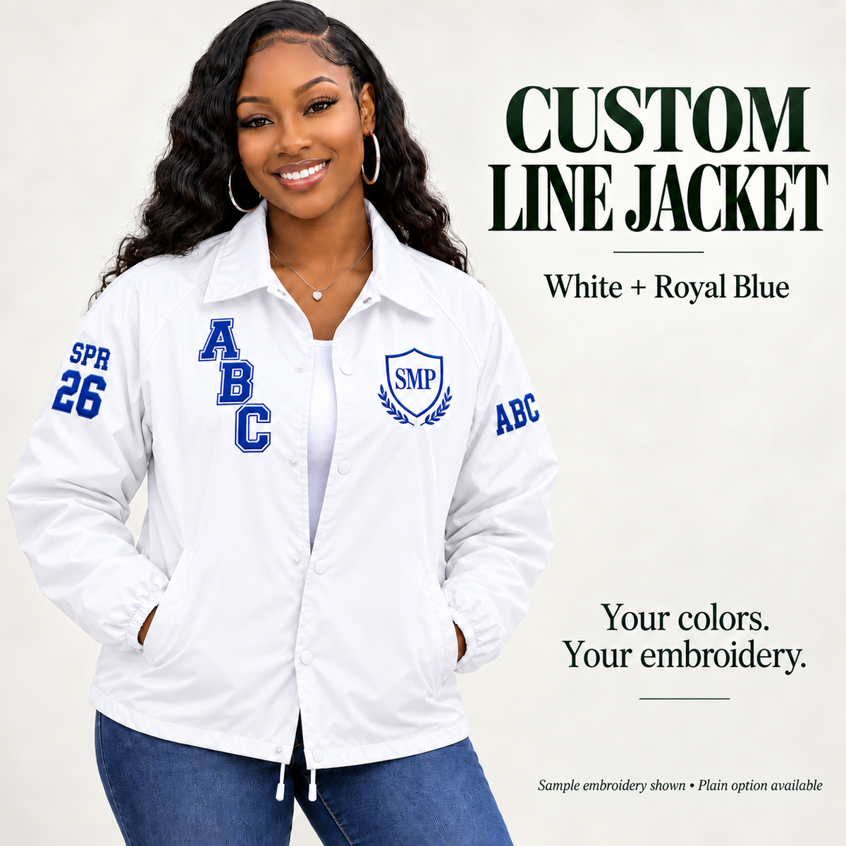 White nylon snap-front line jacket with royal blue sample embroidery on a female model