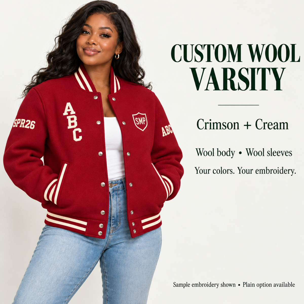 Woman wearing Crimson wool body and wool sleeve varsity jacket with Cream sample embroidery