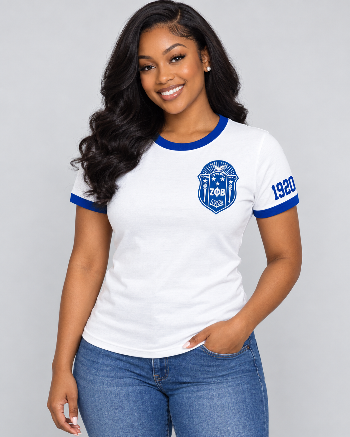 Black woman modeling white Zeta Phi Beta ringer T-shirt with royal blue trim, left chest crest and 1920 on the same-side sleeve