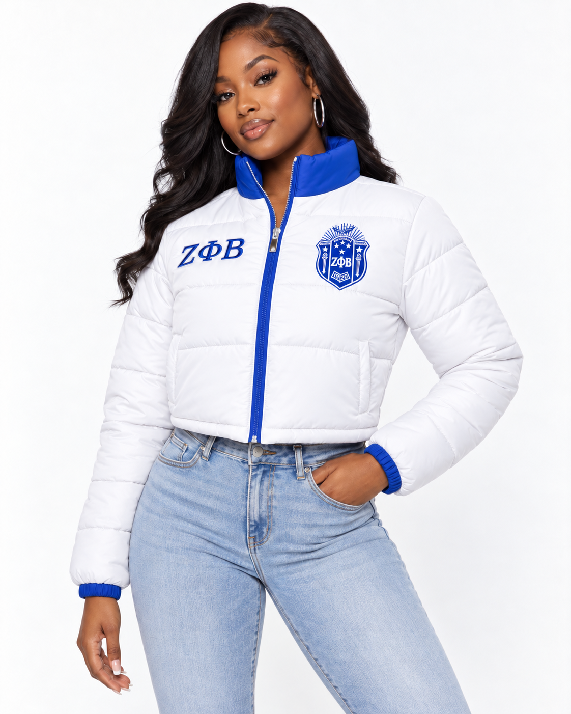 Zeta Phi Beta white cropped puffer jacket with royal blue contrast and embroidery on female model