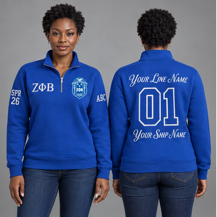 Zeta Phi Beta Royal Blue and White personalized quarter-zip sweatshirt on an adult model, original supplied crest and ΖΦΒ letters, sample line name, line number01, ship name, crossing year and chapter initials.